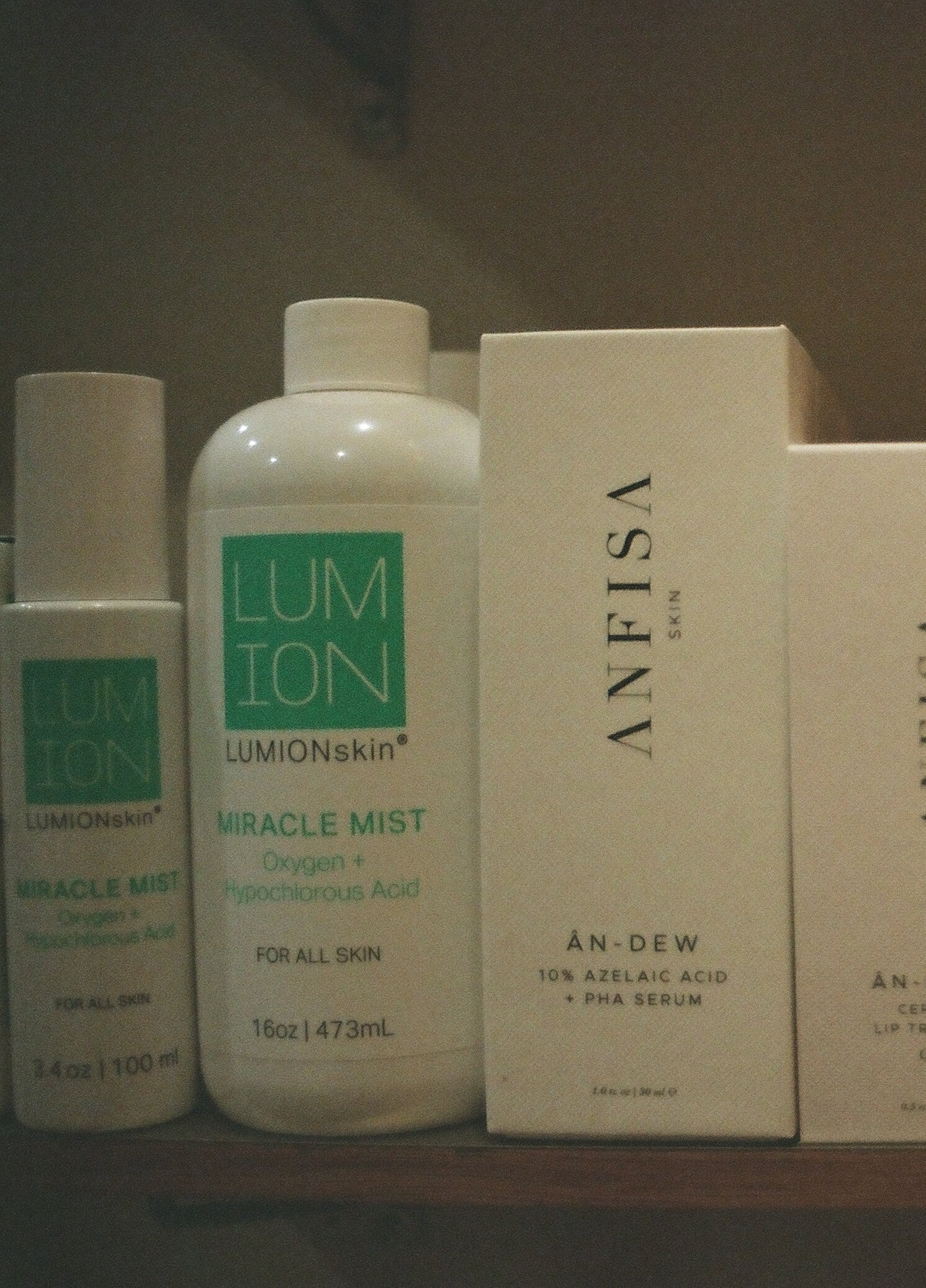 Cosmetic products including bottles and boxes on a shelf with 'ANFISA' branding.